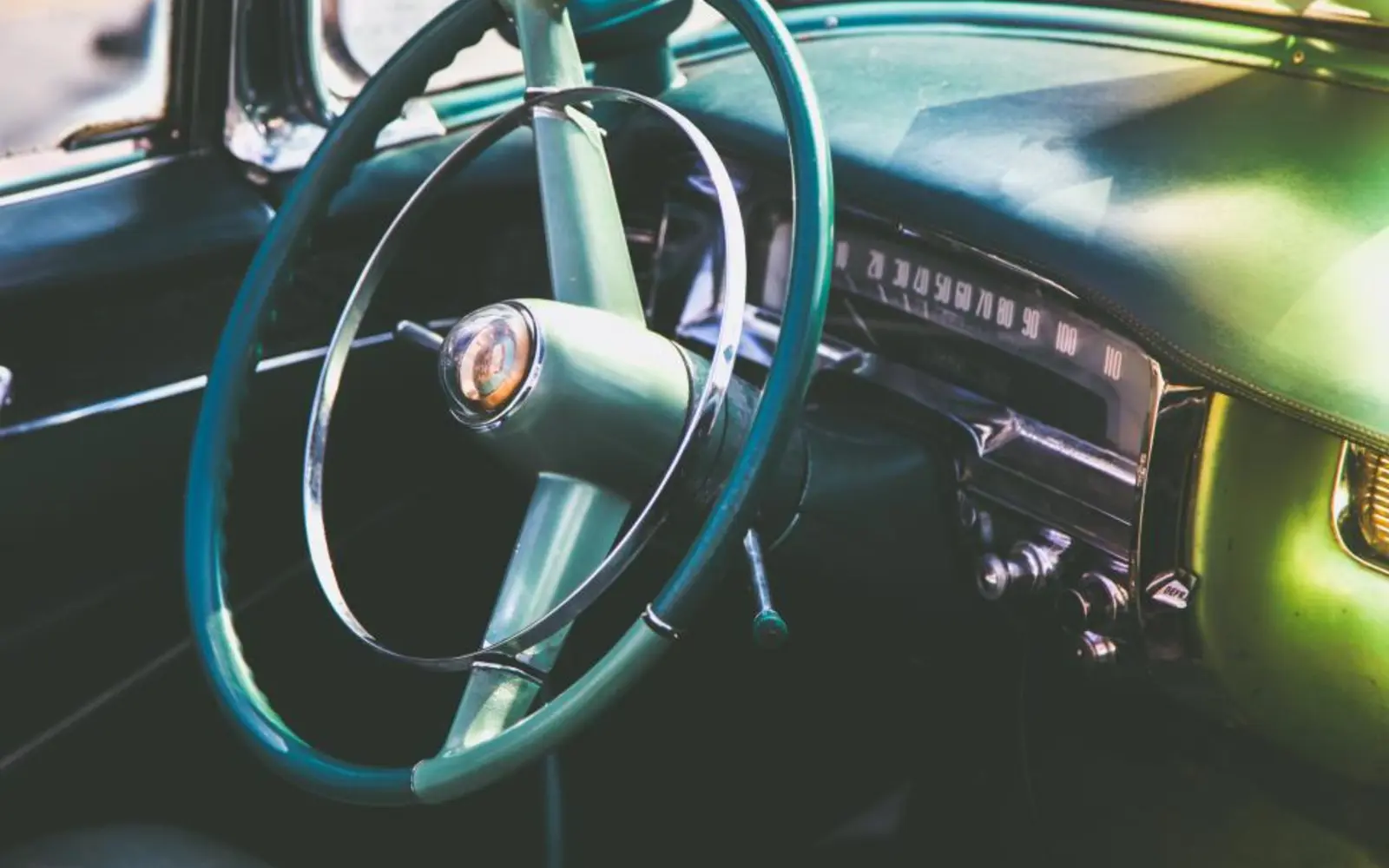 The steering wheel and dashboard of a car
