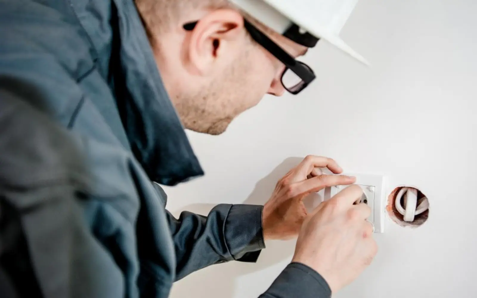 An electrician installing a wall socket