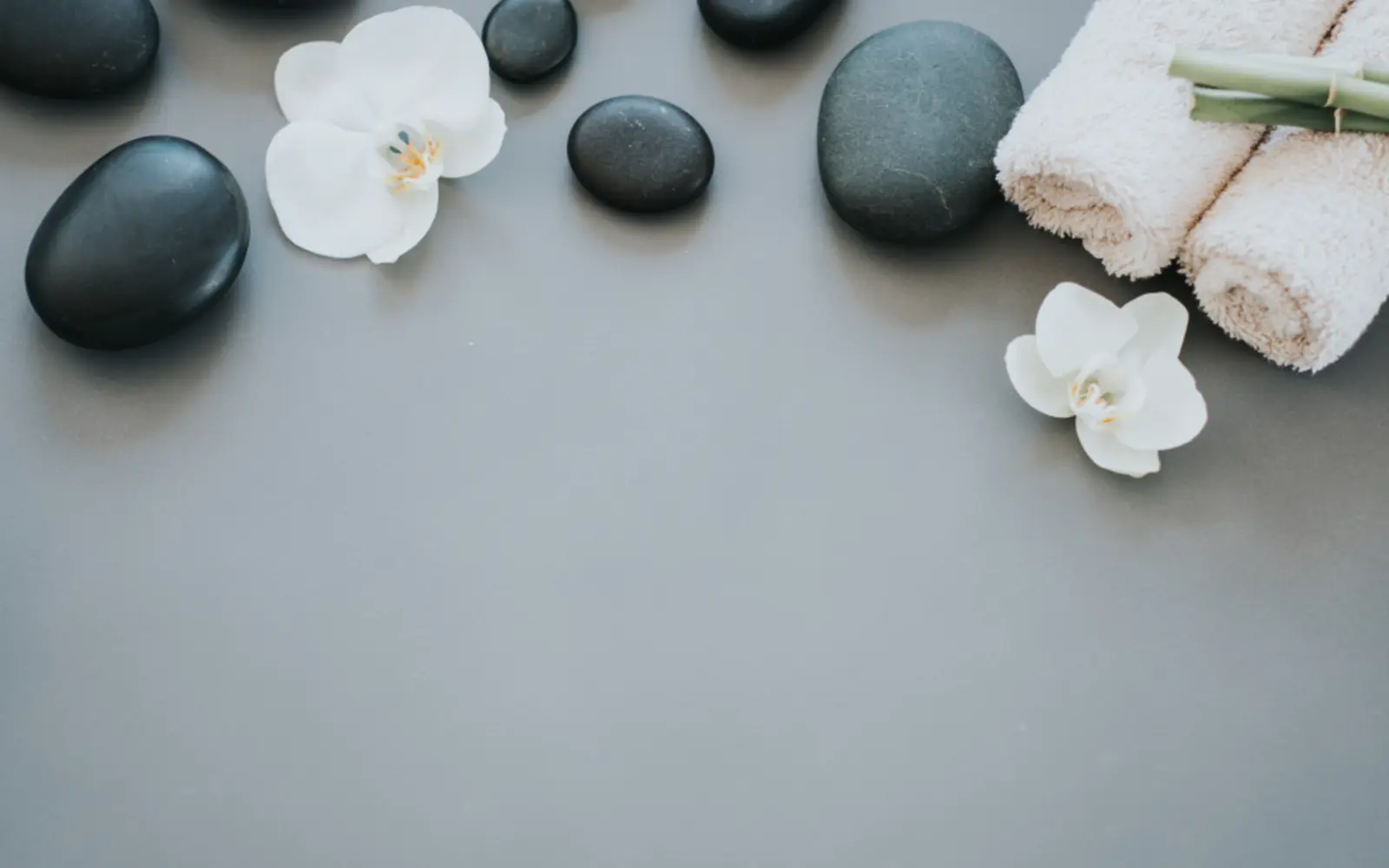 Hot massage stones, rolled towels and orchids